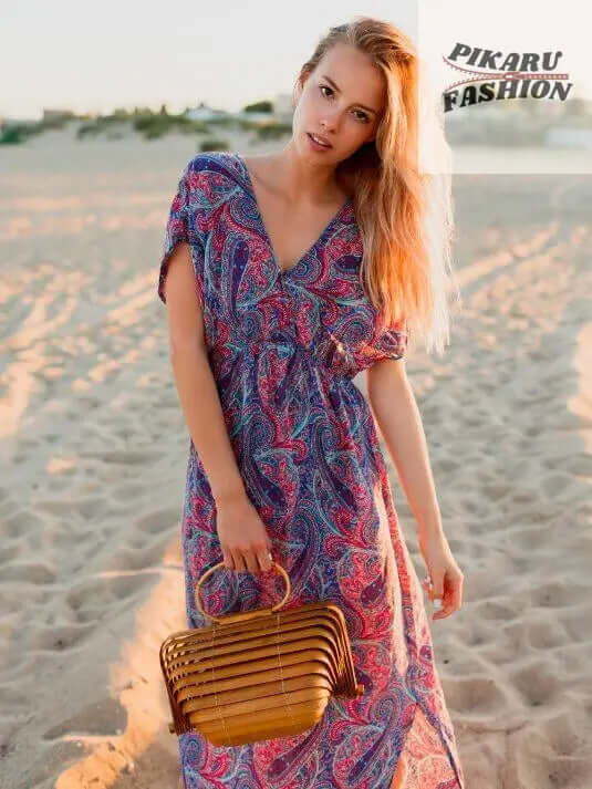 Tie-Dye Maxi - Woman in paisley maxi dress on beach holding bamboo bag