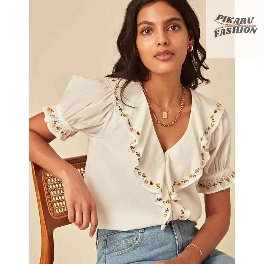  Embroidered Puff Sleeve Top with floral sleeves and ruffle neckline – sitting pose