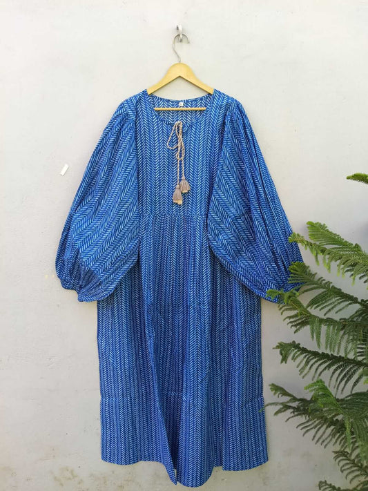 Maxi dress in blue with balloon sleeves and tassel neckline, perfect for stylish, comfortable wear.